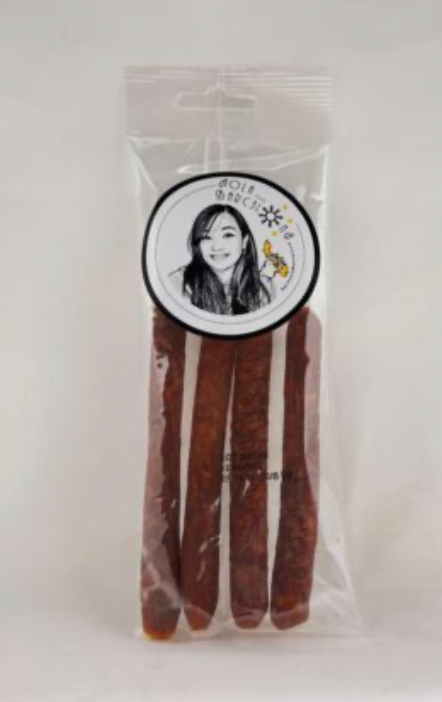 Packaged product with a label featuring a person's face Pinay sa Barcelona on a white background