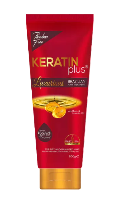 A squeeze tube of Keratin Plus Luxurious Brazilian Hair Treatment with a red body, gold cap, and gold/orange graphic accents, shown on a white background with a red banner at the bottom.